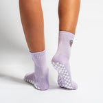 Lavender Austin grip socks with a cowboy-hat smiley face embroidery and a white non-slip traction sole