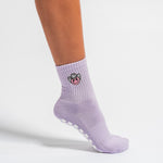 Lavender Austin grip socks with a cowboy-hat smiley face embroidery and a white non-slip traction sole