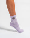 Lavender Austin grip socks with a cowboy-hat smiley face embroidery and a white non-slip traction sole