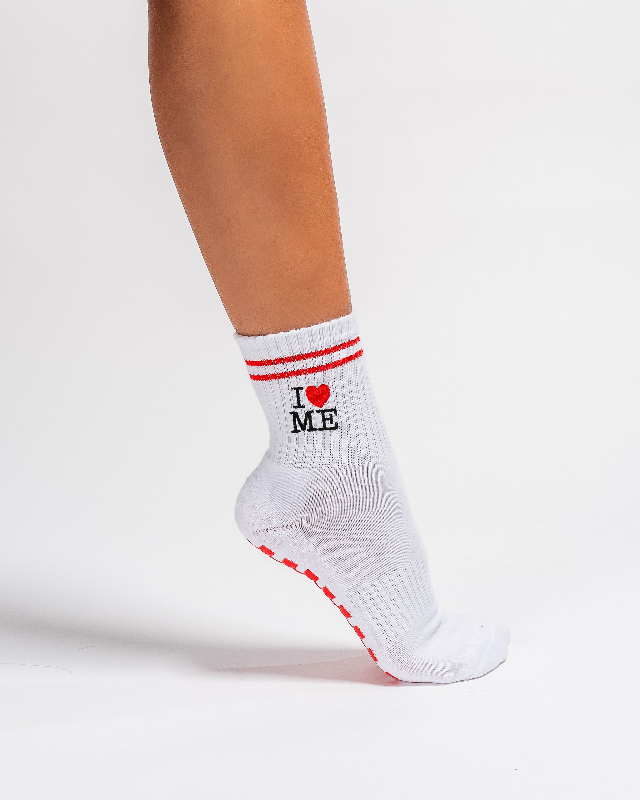 White New York grip socks with red stripes, an "I heart ME" graphic, and a red non-slip patented grip sole
