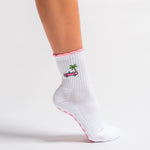 White Los Angeles grip socks with a pink scalloped cuff, pink convertible and palm-tree embroidery, and a pink non-slip patented grip sole