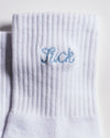 The Pardon My French Grip Sock (Baby Blue) by Revel Athletic features a white ribbed design with “Sick” embroidered in light blue near the cuff, making it perfect as Pilates or barre grip socks for your next studio session.
