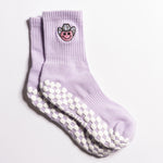 Lavender Austin grip socks with a cowboy-hat smiley face embroidery and a white non-slip traction sole