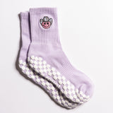 Lavender Austin grip socks with a cowboy-hat smiley face embroidery and a white non-slip traction sole