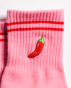 Pink Miami grip socks with red stripes, chili pepper embroidery, and a red non-slip traction sole