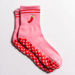 Pink Miami grip socks with red stripes, chili pepper embroidery, and a red non-slip traction sole