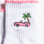 White Los Angeles grip socks with a pink scalloped cuff, pink convertible and palm-tree embroidery, and a pink non-slip patented grip sole