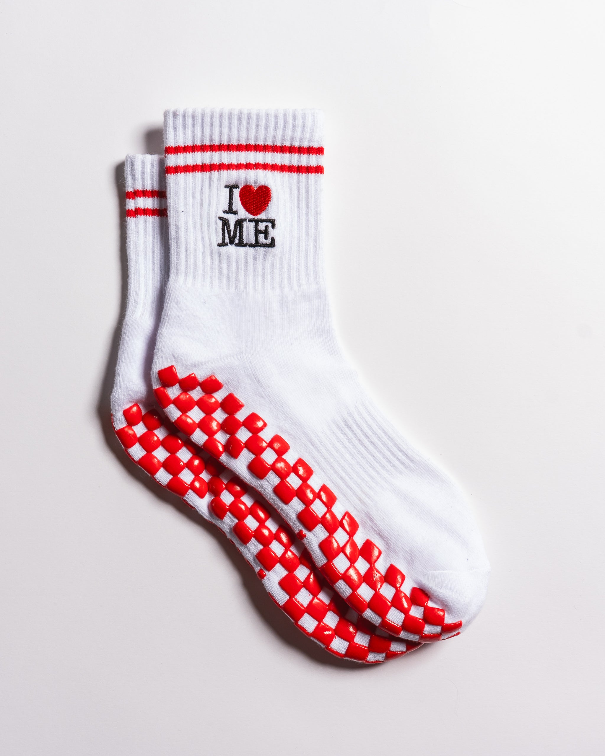 White New York grip socks with red stripes, an "I heart ME" graphic, and a red non-slip patented grip sole