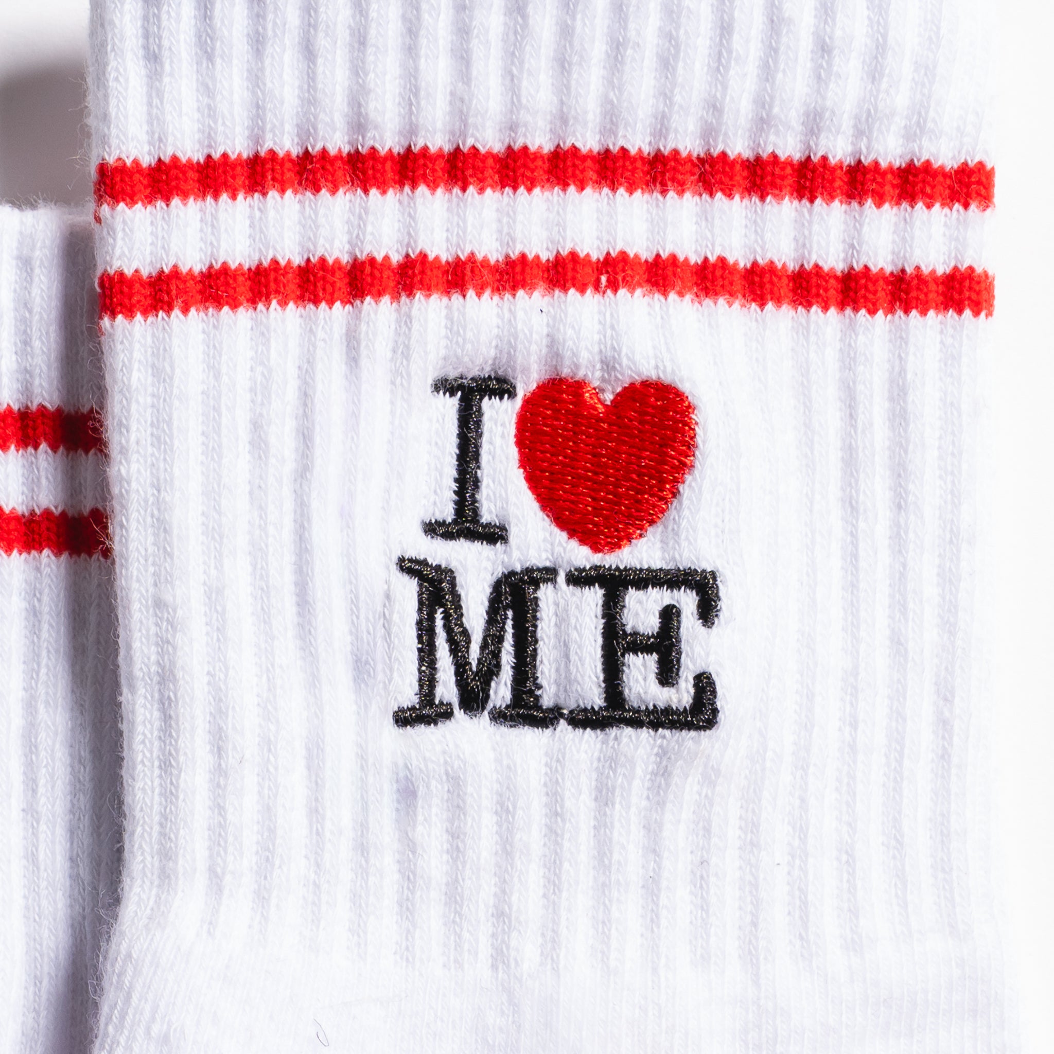White New York grip socks with red stripes, an "I heart ME" graphic, and a red non-slip patented grip sole