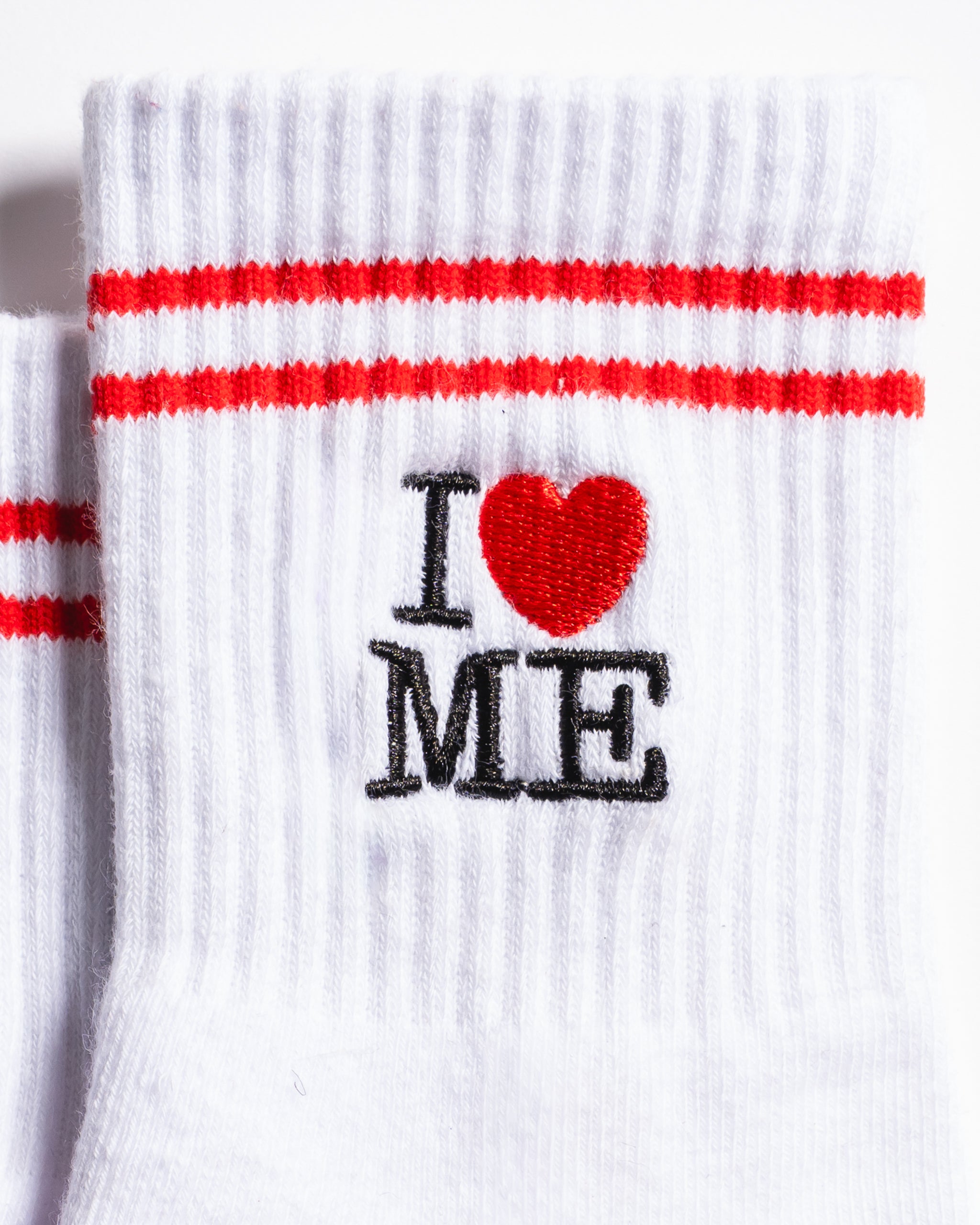 White New York grip socks with red stripes, an "I heart ME" graphic, and a red non-slip patented grip sole