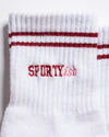 The Sportyish white athletic crew sock with two red stripes at the cuff and the word SPORTYish embroidered in red, designed in the style of GripGrid barre socks.