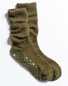 A pair of Revel Athletic’s The Slouch - Olive knit Pilates socks, featuring a relaxed fit in olive green with dark green checkerboard-patterned non-slip grips on the soles, displayed against a white background.