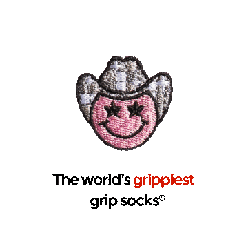 An embroidered pink smiley face with star eyes and a cowboy hat sits above the text, “The world’s grippiest grip socks®.” The word “grippiest” is in red, while all other text is black on a brown background. Perfect for pilates lovers, these grip socks combine standout style with unbeatable functionality.